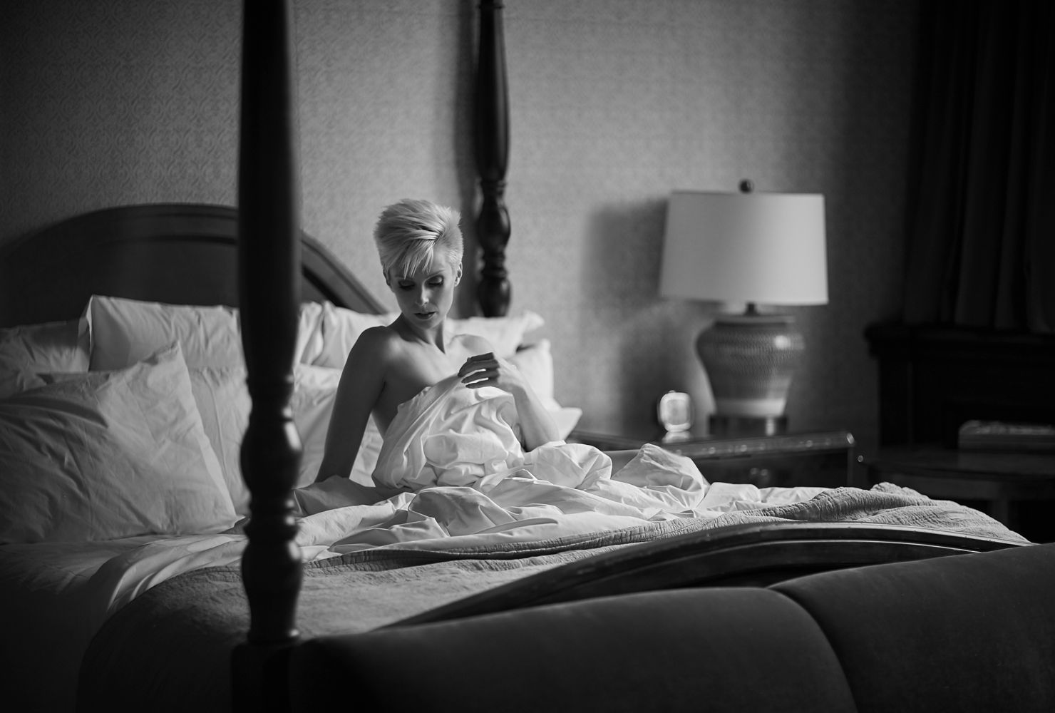 woman laying in bed posing black and white photography chicago boudoir
