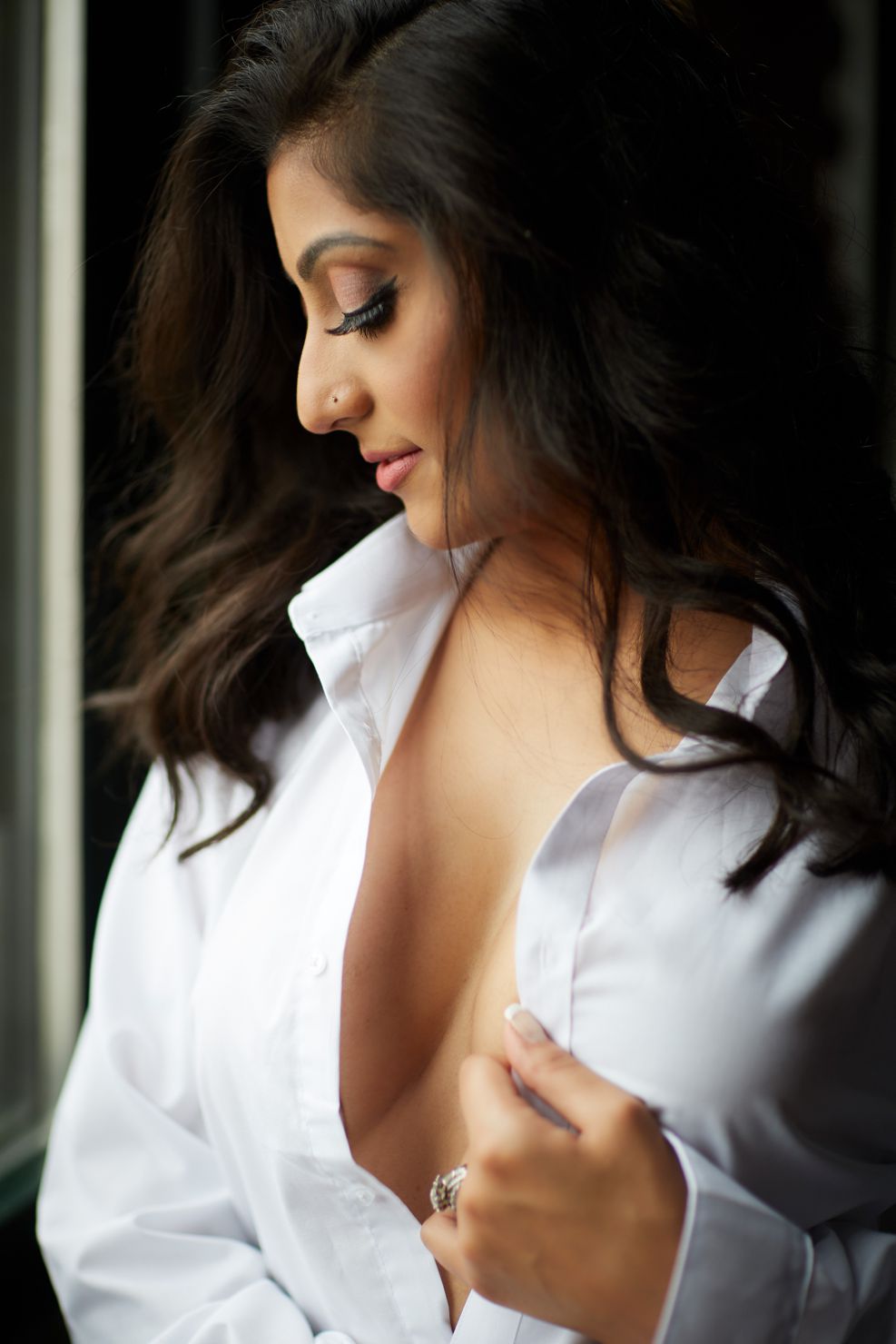 woman looking down wearing button up white shirt boudoir photography chicago
