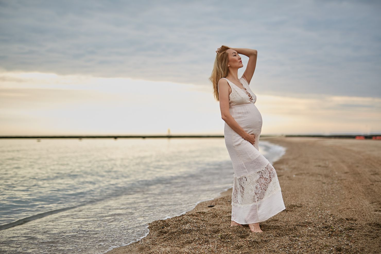 asian woman on beach maternity photography