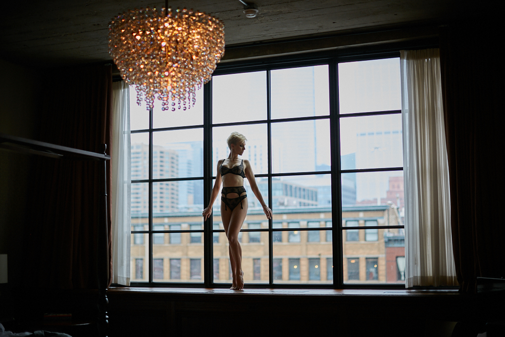 short haired woman standing on window chicago boudoir