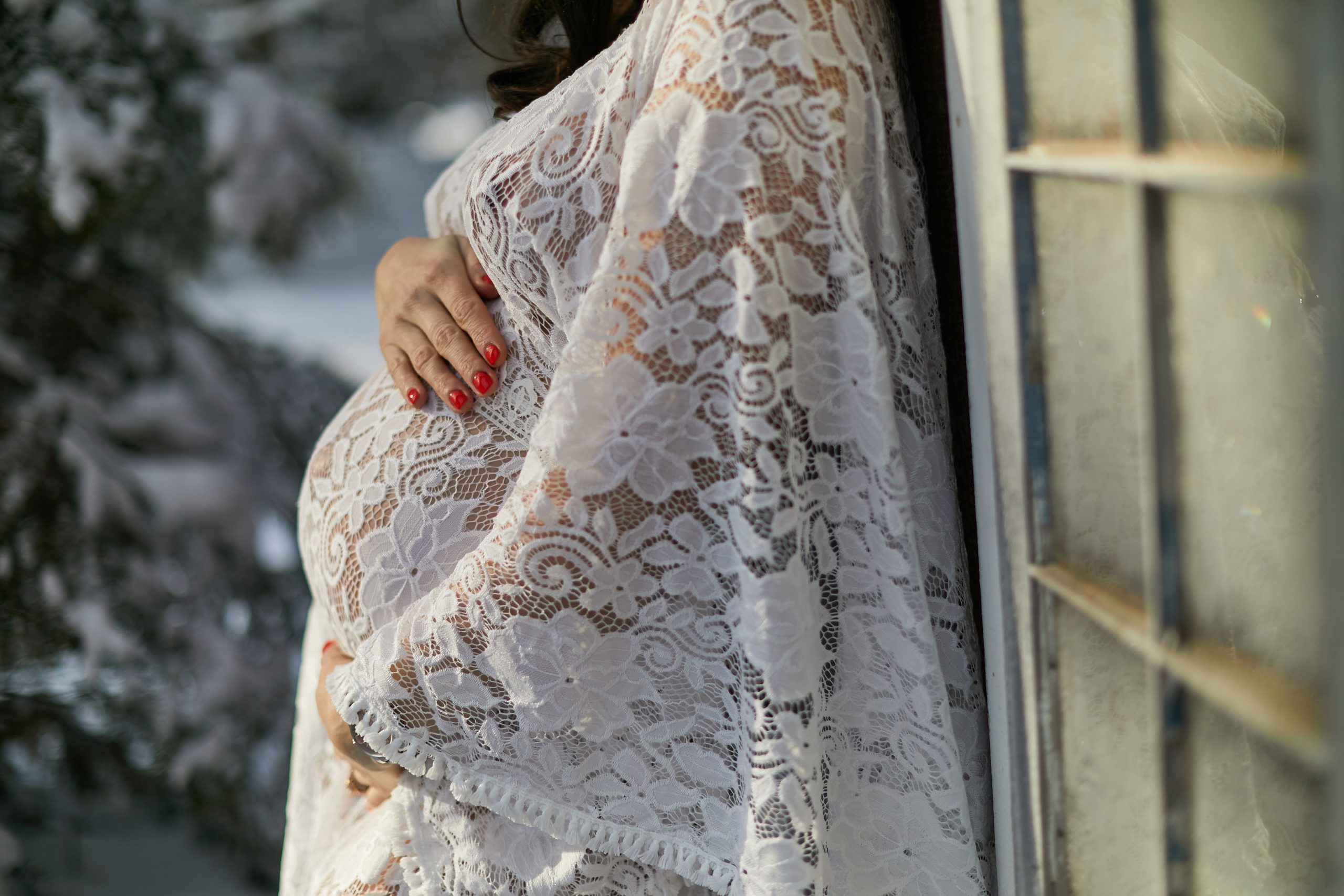 woman holding stomach outdoors maternity boudoir