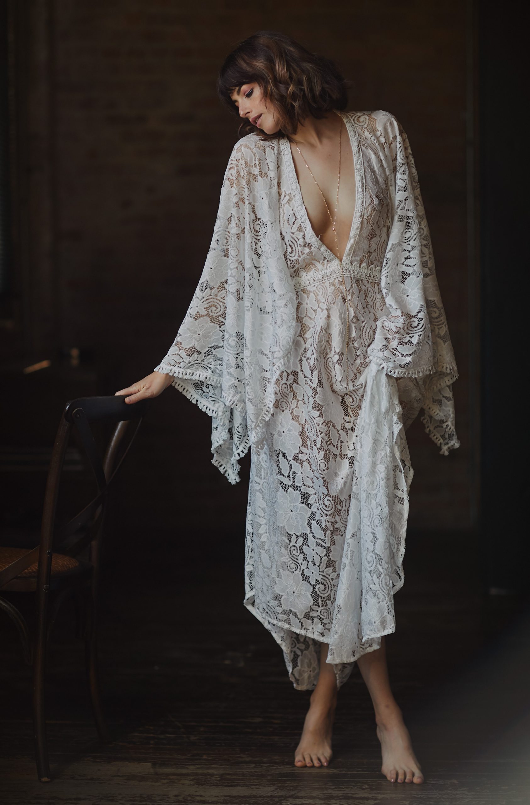 sensual woman standing next to chair in night gown chicago boudoir